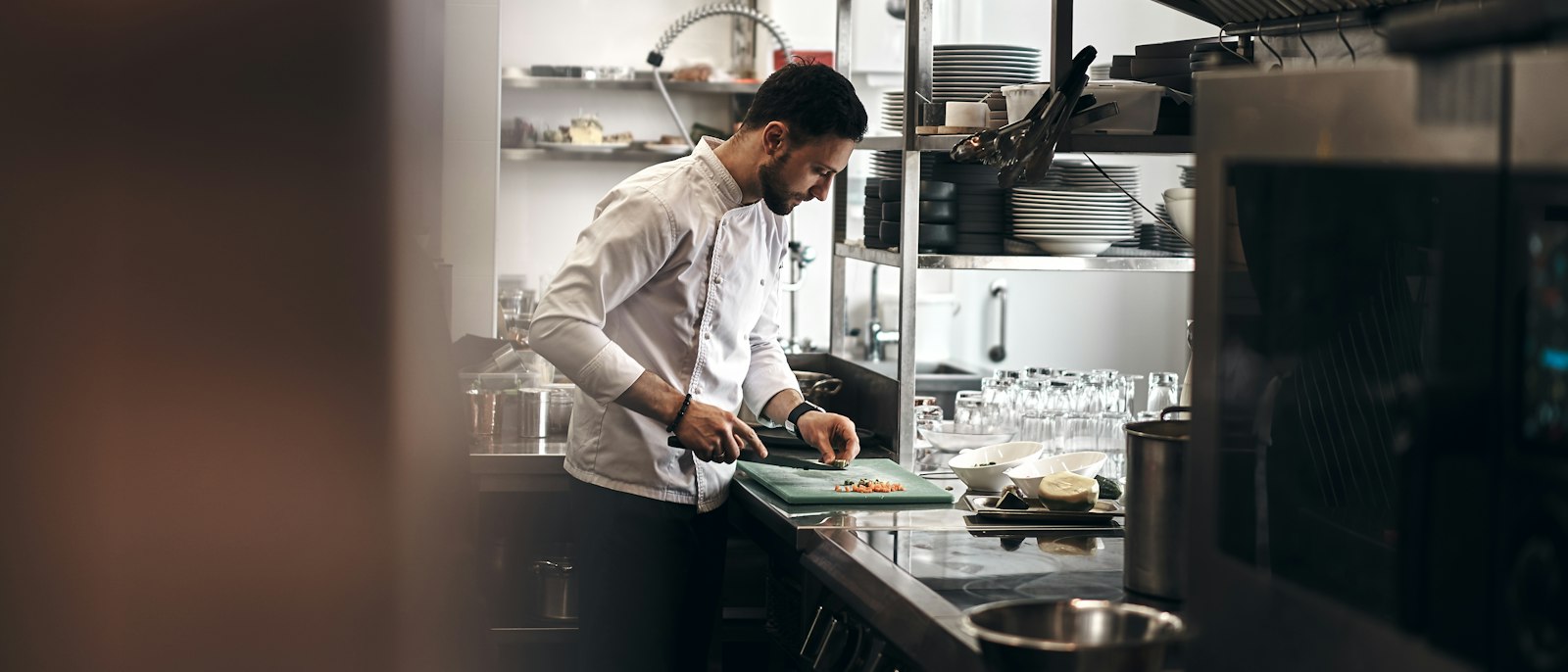 A chef preparing food in a restaurant kitchen